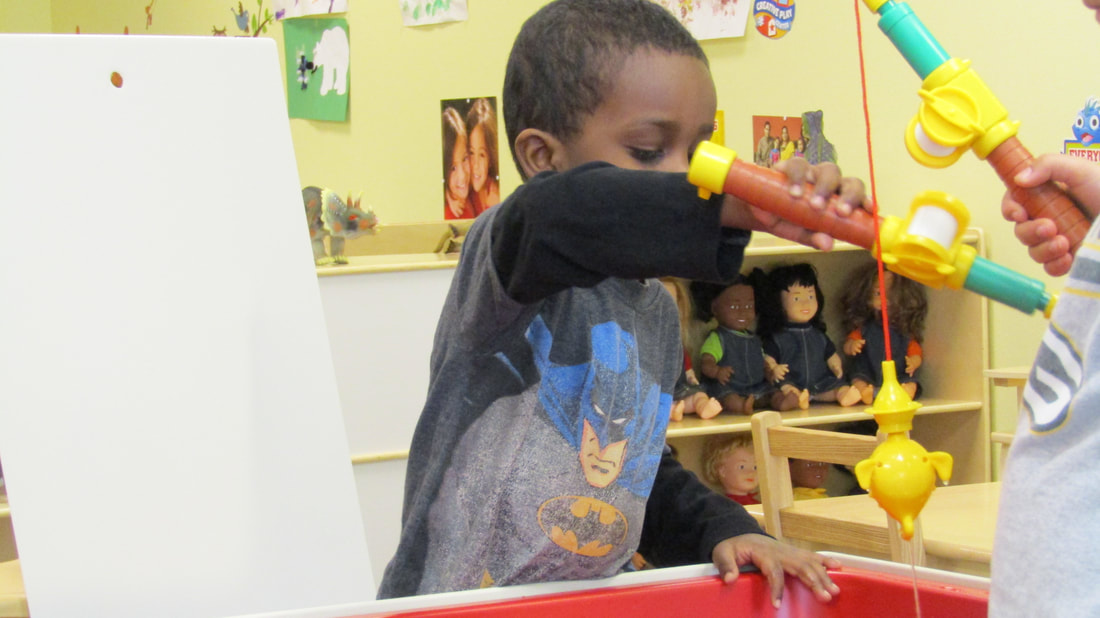 Child exploring a colorful hands-on play station