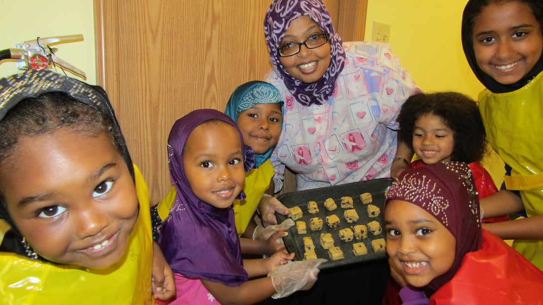 Educator and children making treats together